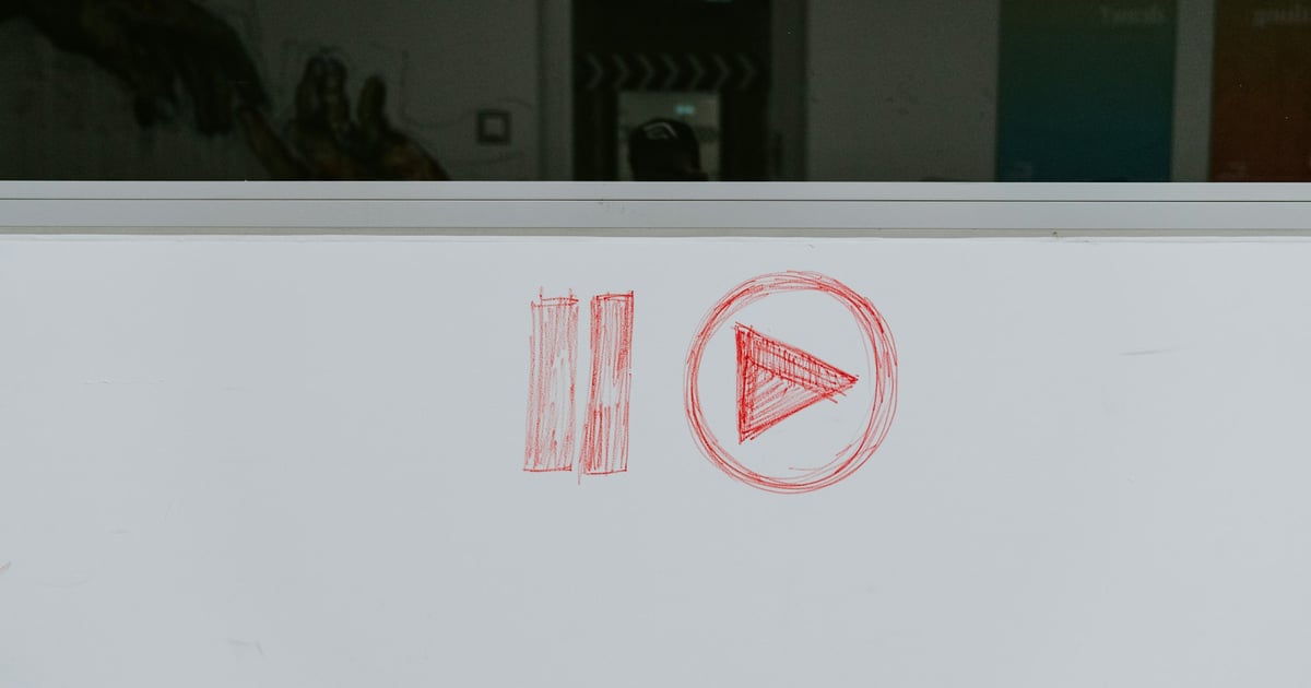 Pause and play icon on whiteboard