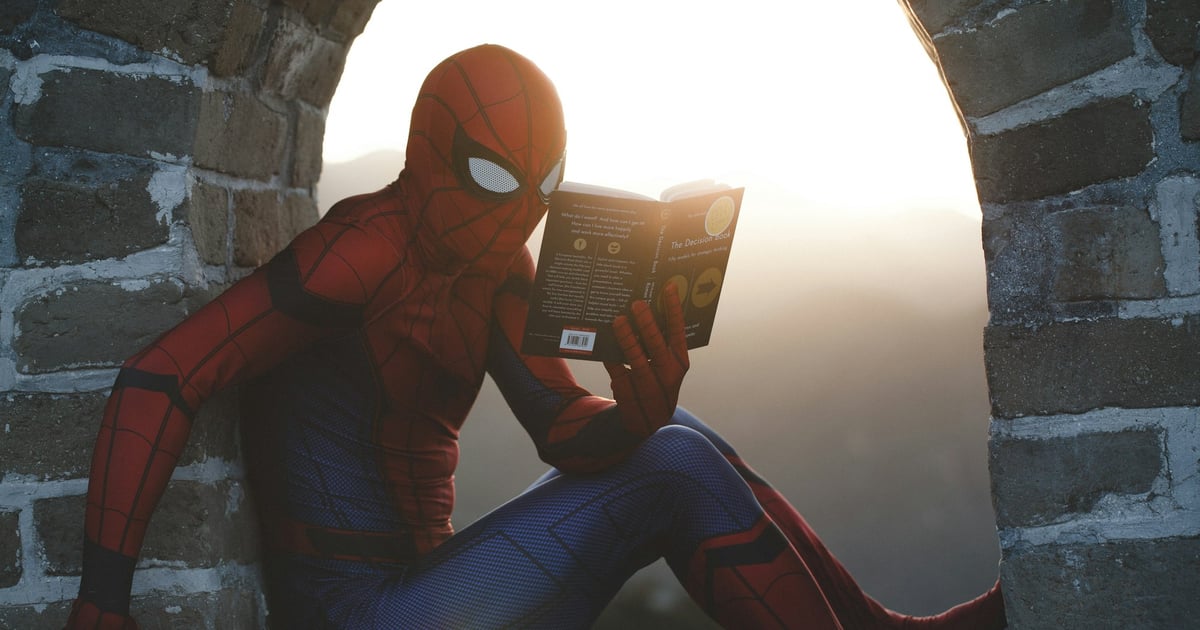 Spiderman reading a book